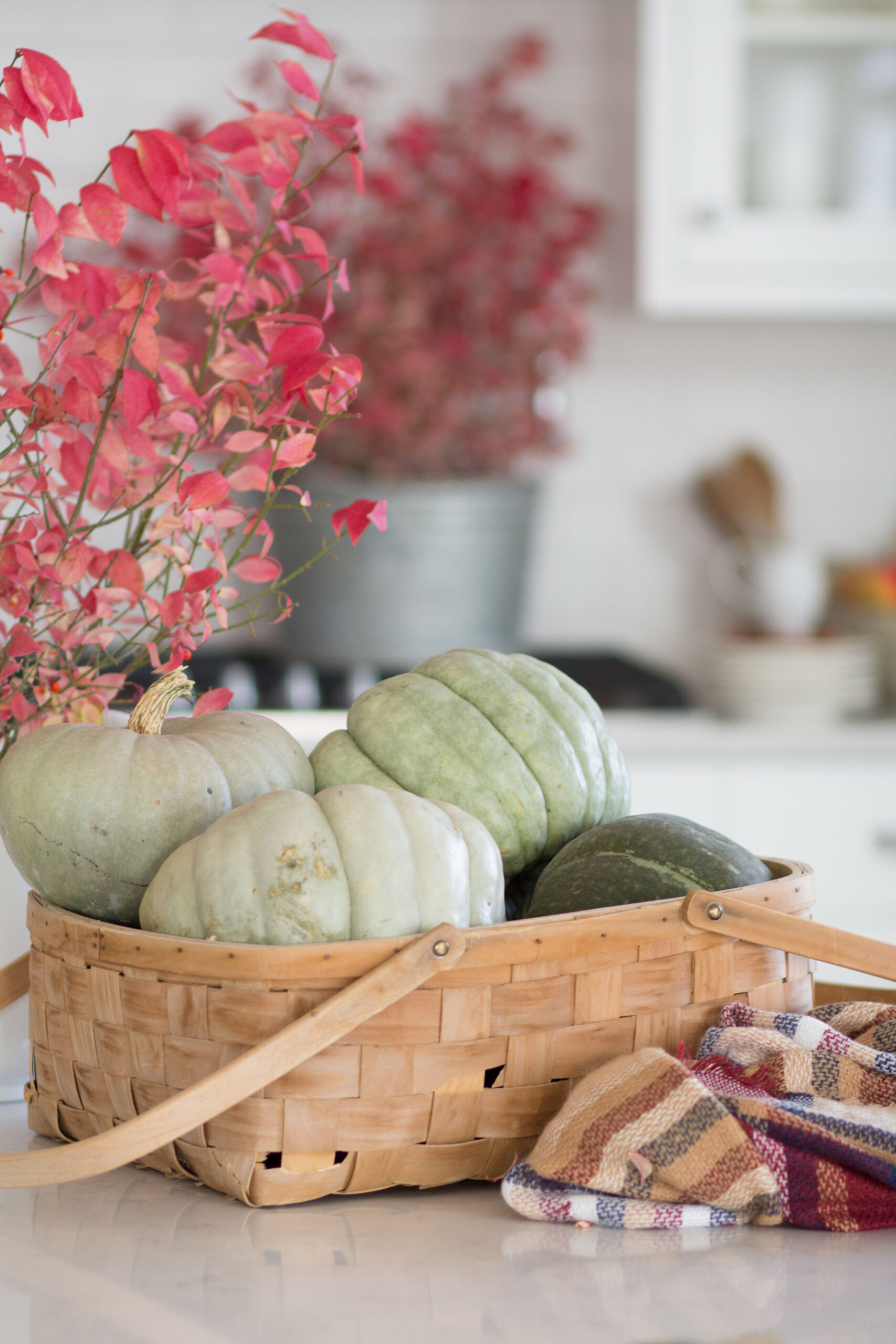 7 Inexpensive or Free Fall Decor Ideas basket of pumpkins and fall kitchen decor 