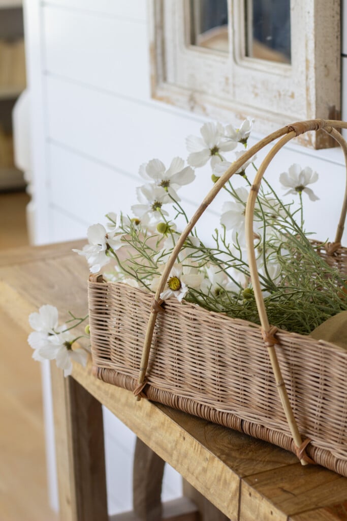 Basket of flowers on entry table.