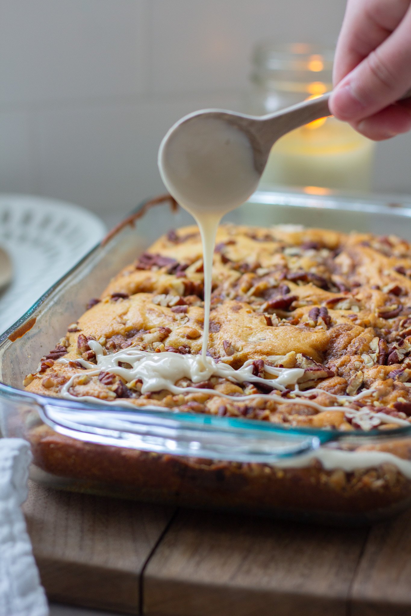 Cinnamon Streusel Coffee Cake with vanilla glaze being drizzled on top 